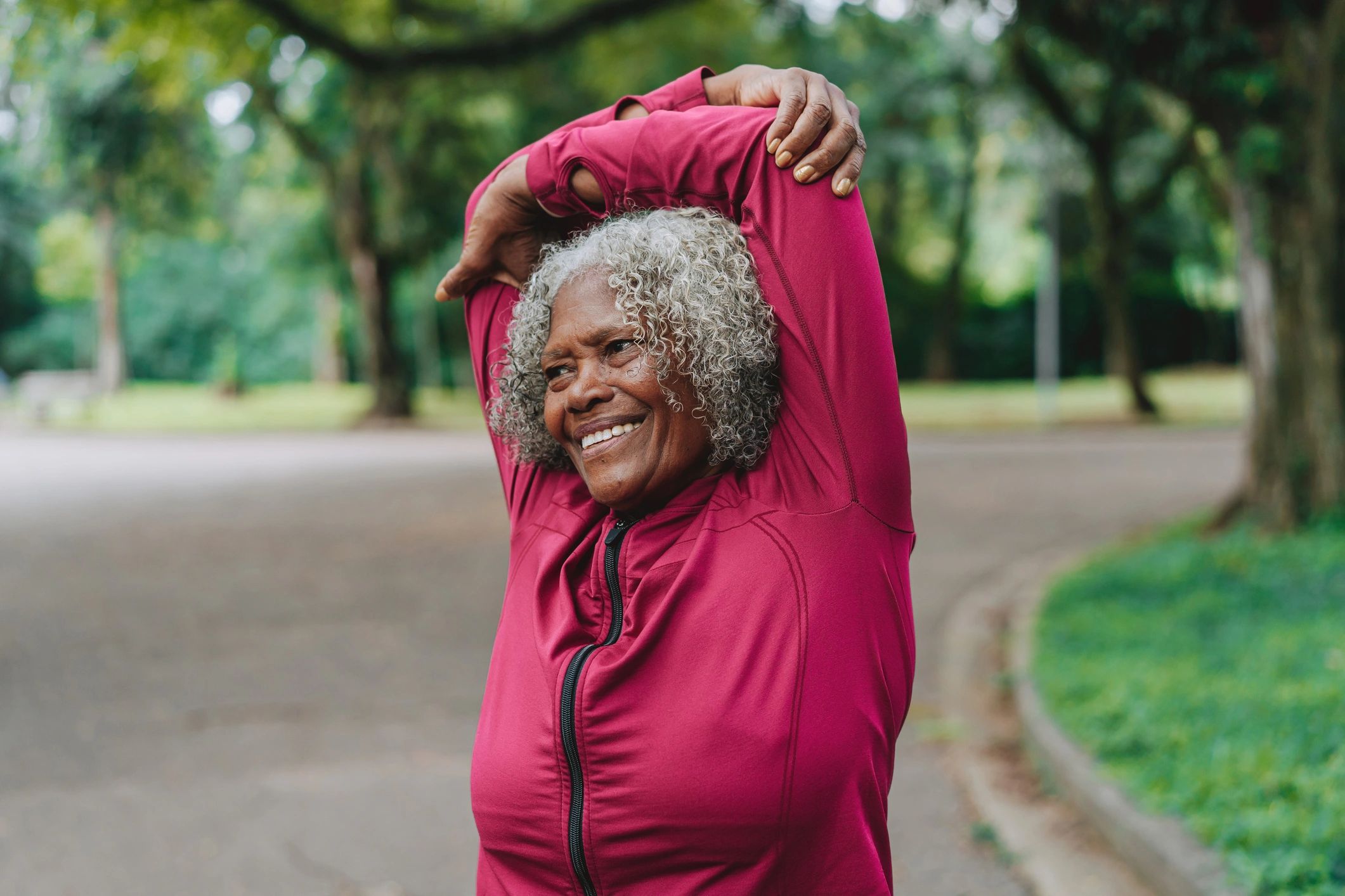 Woman stretching outdoors as part of a healthy wellness routine